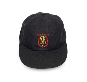 SHANE WARNE'S ST. KILDA CAP, black, with the embroidered "ST K CC" logo embroidered to the front panel. Signed by Warne to the back of the panel. Very good condition. Warne had joined the St. Kilda Cricket Club for the 1985-86 season when he was 16 years old. Provenance: Charles Leski Auction 24 Sept. 2008.
