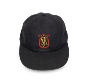 SHANE WARNE'S ST. KILDA CAP, black, with the embroidered "ST K CC" logo embroidered to the front panel. Signed by Warne to the back of the panel. Very good condition. Warne had joined the St. Kilda Cricket Club for the 1985-86 season when he was 16 years