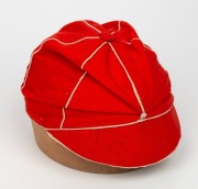 A TASMANIAN COLONIAL CRICKET CAP from the late 19th Century, red with white piping, a button-down peak, and with an illegible signature under the brim. Although worn in places, in remarkably good condition for one of the oldest surviving Australian cricke - 2