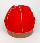 A TASMANIAN COLONIAL CRICKET CAP from the late 19th Century, red with white piping, a button-down peak, and with an illegible signature under the brim. Although worn in places, in remarkably good condition for one of the oldest surviving Australian cricke - 3