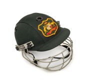 GLENN McGRATH'S AUSTRALIAN TEST TEAM BATTING HELMET, green, with the Australian coat-of-arms embroidered to the front panel; a "TEST 2000" type, made by Albion and dated 94-95 on their label to the right side of the protective grill; signed (and dedicated