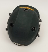 GLENN McGRATH'S AUSTRALIAN TEST TEAM BATTING HELMET, green, with the Australian coat-of-arms embroidered to the front panel; a "TEST 2000" type, made by Albion and dated 94-95 on their label to the right side of the protective grill; signed (and dedicated - 5