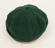 GRAEME WOOD'S AUSTRALIAN TEST TEAM BAGGY GREEN from the 1985 Ashes Tour of England, with the Australian coat-of-arms embroidered to the front panel; made by Albion, with their original label which also bears Wood's original signature in ink. Fine conditio - 5