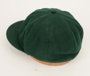 GRAEME WOOD'S AUSTRALIAN TEST TEAM BAGGY GREEN from the 1985 Ashes Tour of England, with the Australian coat-of-arms embroidered to the front panel; made by Albion, with their original label which also bears Wood's original signature in ink. Fine conditio - 6