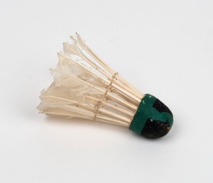 AN EARLY 20th CENTURY SHUTTLECOCK: by F.H. Ayres Ltd. (with their stamp on the internal surface), circa 1910; an Ässociation "shuttle", with original green reinforcing tape.