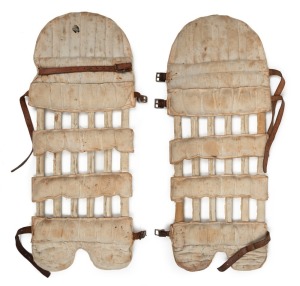 A pair of late-nineteenth century match-used "skeleton" open-ribbed cane and leather cricket pads, with leather straps and buckles. (2). Each approx. 67cm.