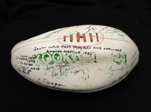 A Kookaburra white football, titled 'SOUTH MELB. PAST PLAYERS and OFFICIALS ANNUAL MEETING 1985' with signatures including Kevin Doolan, Jim Kennelly, Jeff McGee, Jack Lugg, Peter Tippett, Ian Tampion, Alan Miller, Tom Crane and many others.