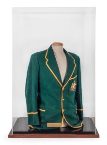 THE 1954-55 AUSTRALIAN TEST TEAM CRICKET BLAZER WORN BY LEN MADDOCKS, during the Test Series against the West Indies, green wool with gold piping, the Australian coat-of-arms, and the date "1954-55" embroidered in silk to the jacket pocket; attractively presented in a custom-made perspex case with timber base. Accompanied by a CoA signed by Len Maddocks together with associated paperwork; overall 105 x 67 x 41cm.