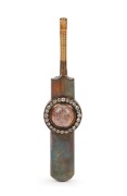 THE BLACKHAM BROOCH, a piece of the original 'Blackham Ball' used by Frederick Spofforth during the first Ashes Test against England in London in 1882; inset under a rock crystal dome within a circlet of 24 old-cut diamonds and mounted in a 15 carat yello