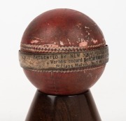 ARTHUR MORRIS: Mounted presentation cricket ball with a sterling silver ring engraved "PRESENTED BY NEW SOUTH WALES Cricket Associated To A. R. MORRIS in Recognition of His World's Record Performance, a Century in Each Innings (146 and 111) of His 1st Cla - 2