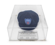 ARTHUR MORRIS'S BLUES LIVING LEGENDS TEAM BAGGY BLUE CAP: Blue wool, embroidered "NSWCA" logo on front, in perspex display case. The case 14cm high, 30cm wide, 40cm deep.