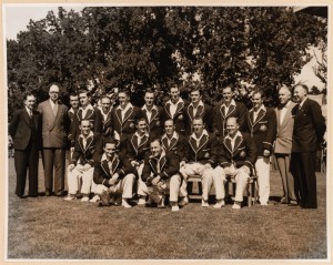A large format (29.5 x 37.5cm) press photograph, signed verso by Sam Loxton, showing ten members of the 1948 Australian team during a visit to a private garden - admiring the goldfish; also, a team-issued photograph of the 1956 Australians in England, with Miller, Johnson, McDonald and Harvey. (2).