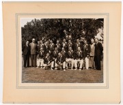 A large format (29.5 x 37.5cm) press photograph, signed verso by Sam Loxton, showing ten members of the 1948 Australian team during a visit to a private garden - admiring the goldfish; also, a team-issued photograph of the 1956 Australians in England, wit - 2