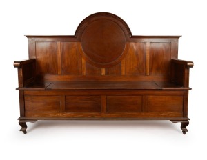 FROM WALTER LINDRUM'S BILLIARDS ROOM: An antique Australian blackwood hall bench with lift-up compartment seat and break arch back rest with recessed circular panel, circa 1920, 136cm high, 190cm wide, 54cm deep