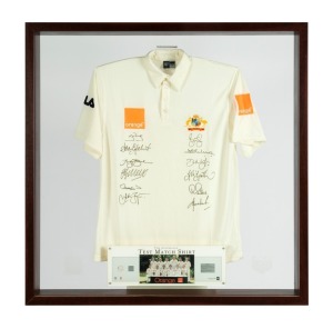 "THE AUSTRALIAN TEST MATCH SHIRT, 2002-2003" number 88 from a limited edition of 200, produced by the Australian Cricket Board, with an official Australian short sleeved shirt bearing the Australian coat-of-arms embroidered in silk, the orange sponsorship patches and the original signatures of the twelve members of the Test team including Steve Waugh, Adam Gilchrist, Glenn McGrath. Attractively framed, 120 x 120cm overall. (Very large and heavy!)
