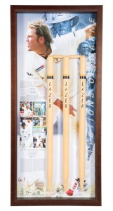 "RECOLLECTIONS OF WARNE" attractive display combining action photographs and details of Warne's career signed by him and including a full size set of wickets and bails, numbered 25 of a limited edition of 145, accompanied by a PWC CofA. Framed and glazed, 115 x 53cm overall.