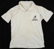 ex NATHAN BUCKLEY COLLECTION: Port Adelaide Premiers polo, 1992. White polo shirt with magpie caricature on breast pocket and the words &lsquo;Magpies Premiers &lsquo;92&rsquo;