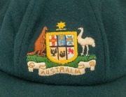 CLARRIE GRIMMETT'S AUSTRALIAN&nbsp;"BAGGY GREEN" PRESENTATION&nbsp;TEST CAP: Green wool, with embroidered coat-of-arms that differs that differs from the usual design. This cap bears the official Australian coat-of-arms as set out in the 1912 Royal Warrant. It show - 2