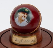 An Australian cricket tie, circa 1985; together with a Don Bradman presentation cricket ball, limited edition 501/974, a signed yellow cricket and a signed kookaburra cricket ball on stand, (4 items) - 4