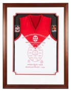 SYDNEY SWANS 2005 Premiership souvenir display featuring a specially printed Premiership Team jersey framed together with signed Paul Roos and Barry Hall collector cards; with a C of A verso. Framed & glazed. Overall 109 x 84cm