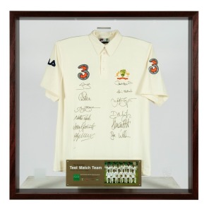"THE AUSTRALIAN TEST MATCH TEAM - AUSTRALIA V INDIA TEST SERIES 2003/2004", limited edition, produced by the Australian Cricket Board, with an official Australian short sleeved shirt bearing the Australian coat-of-arms embroidered in silk, the "3" sponsorship patches and the original signatures of the twelve members of the Test team including Steve Waugh, Adam Gilchrist, Jason Gillespie, Matthew Hayden, and Justin Langer. Attractively framed, 120 x 120cm overall. (Very large and heavy!)