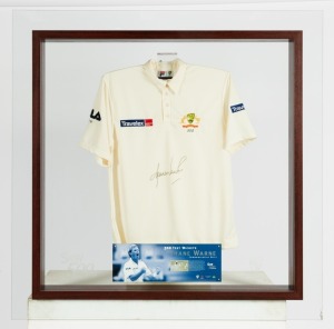 "SHANE WARNE 500 TEST WICKETS" Commemorative Shirt: an Australian Test team short-sleeved shirt with the Australian logo and Warne's team number "350" embroidered in silk together with Travelex sponsorship logos, and signed by Shane Warne; attractively presented in a framed display together with a ACB/PWC CoA, 120 x 120cm overall. (Very large and heavy!)