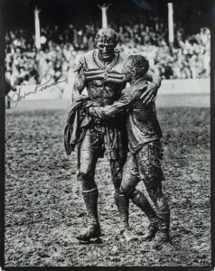 NORM PROVAN and ARTHUR SUMMONS, original signatures on a large format print of the iconic photograph by John O'Gready, known as "The Gladiators"; overall 43 x 34cm.