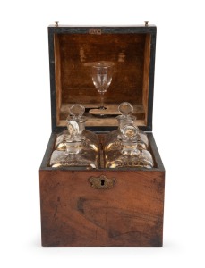 An antique English mahogany four bottle spirit tantalus with original gilt decorated decanters and glass, circa 1830, 23cm high, 18cm wide, 18cm deep