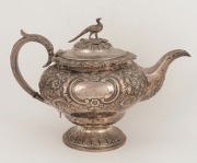An antique Scottish sterling silver teapot with&nbsp;repousse floral decoration and pheasant finial, made in Edinburgh, circa 1834, 18cm high, 27cm wide, 766 grams - 2
