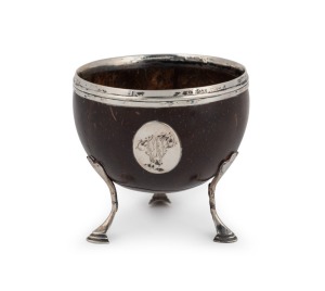 An antique sterling silver mounted coconut cup resting on pad feet, circa 1800, 9cm high