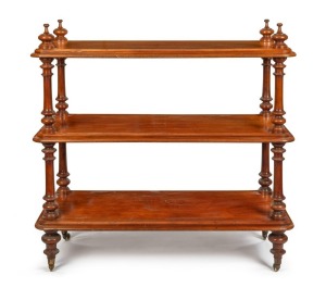 An antique Australian cedar three tier dumbwaiter with turned column supports and spire finials, all resting on original brass casters, Melbourne origin, circa 1870, ​​​​​​​118cm high, 124cm wide, 55cm deep