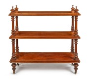 An antique Australian cedar three tier dumbwaiter with turned column supports and spire finials, all resting on original brass casters, Melbourne origin, circa 1870, ​​​​​​​118cm high, 124cm wide, 55cm deep