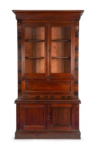 REDMOND BARRY'S BOOKCASE, Australian cedar secretaire bookcase with carved lamb's tongue corbels and fall front, interior fitter with writing slope, drawers and compartments, manufactured by GEORGE THWAITES of Melbourne, 19th century. 245cm high, 140cm wide, 62cm deep.
