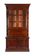 REDMOND BARRY'S BOOKCASE, Australian cedar secretaire bookcase with carved lamb's tongue corbels and fall front, interior fitter with writing slope, drawers and compartments, manufactured by GEORGE THWAITES of Melbourne, 19th century. 245cm high, 140cm w