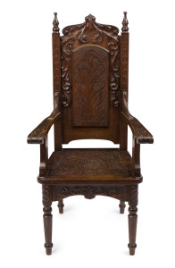 An Australian blackwood carver chair, early 20th century, decorated with carved orchids, monogram and dated "E.Y.C. 6th Sept. 1904", 53cm across the handles