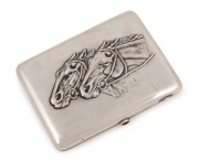 An antique Russian silver cigarette case with repousse horse decoration and cabochon&nbsp;ruby clasp, 19th/20th century, 11.5cm wide, an impressive 218 grams