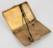 An antique Russian silver cigarette case with repousse horse decoration and cabochon&nbsp;ruby clasp, 19th/20th century, 11.5cm wide, an impressive 218 grams - 2