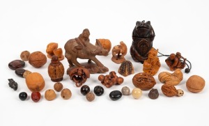 Assorted carved walnut ornaments, carved boxwood netsukes, beads etc., 20th century, (qty), the largest 9cm high
