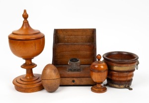 A Georgian treen ware brass bound bowl with lion mask and paw fittings; together with two lidded treen ware urns, a treen ware egg and an antique timber inkwell stationery box with hand-written note proclaiming it to be the third prize in a 100 yard race,