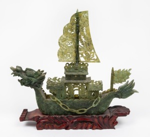 A Chinese carved jade dragon boat on timber stand, 20th century, 35cm high