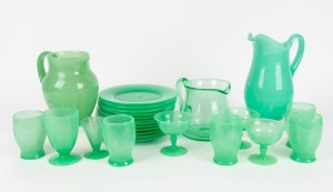 A French Art Deco&nbsp;jade&nbsp;green uranium&nbsp;glass mixed dinner service, comprising of 12 plates, 5 tumblers, 3 champagne coupes, liqueur&nbsp;glass, footed tumbler and 3 water jugs, circa 1930s, the largest jug 21cm high.