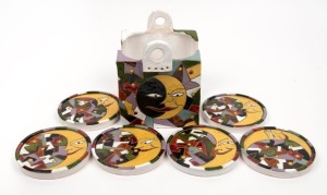 "Man in the Moon" six vintage hand-painted and glazed coasters with matching&nbsp;caddy, (7 items), the caddy 17cm high.