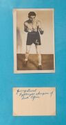 An album containing a collection of signed photographs, cards, postcards and cuttings, with the signatories including Archie Moore, Dado Marino, Sam Ichinose, Freddie Mills, Doug Miller, Rinty Monaghan, Andries Steyn, Manuel Ortiz, Danny O'Sullivan, Jim P - 10