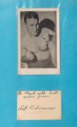 An album containing a collection of signed photographs, cards, postcards and cuttings, with the signatories including Archie Moore, Dado Marino, Sam Ichinose, Freddie Mills, Doug Miller, Rinty Monaghan, Andries Steyn, Manuel Ortiz, Danny O'Sullivan, Jim P - 12