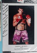 An album containing a collection of signed photographs, cards, postcards and cuttings, with the signatories including Archie Moore, Dado Marino, Sam Ichinose, Freddie Mills, Doug Miller, Rinty Monaghan, Andries Steyn, Manuel Ortiz, Danny O'Sullivan, Jim P - 14