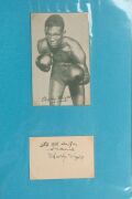 An album containing a collection of signed photographs, cards, postcards and cuttings, with the signatories including Archie Moore, Dado Marino, Sam Ichinose, Freddie Mills, Doug Miller, Rinty Monaghan, Andries Steyn, Manuel Ortiz, Danny O'Sullivan, Jim P - 16