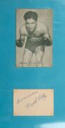 An album containing a collection of signed photographs, cards, postcards and cuttings, with the signatories including Archie Moore, Dado Marino, Sam Ichinose, Freddie Mills, Doug Miller, Rinty Monaghan, Andries Steyn, Manuel Ortiz, Danny O'Sullivan, Jim P - 24