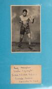 An album containing a collection of signed photographs, cards, postcards and cuttings, with the signatories including Archie Moore, Dado Marino, Sam Ichinose, Freddie Mills, Doug Miller, Rinty Monaghan, Andries Steyn, Manuel Ortiz, Danny O'Sullivan, Jim P - 25