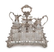 An English Georgian sterling silver nine piece cruet set with Rococo&nbsp;floral border standing on acanthus and shell feet. The cruet bottles of&nbsp;reeded crystal form with conforming acanthus silver mounts. Made by&nbsp;Joseph Angell of London, 26cm high, 27cm wide,