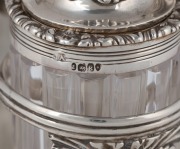 An English Georgian sterling silver nine piece cruet set with Rococo&nbsp;floral border standing on acanthus and shell feet. The cruet bottles of&nbsp;reeded crystal form with conforming acanthus silver mounts. Made by&nbsp;Joseph Angell of London, 26cm high, 27cm wide, - 4